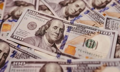 Pile of 100 dollar bills depicting wealth and financial success in close-up view.